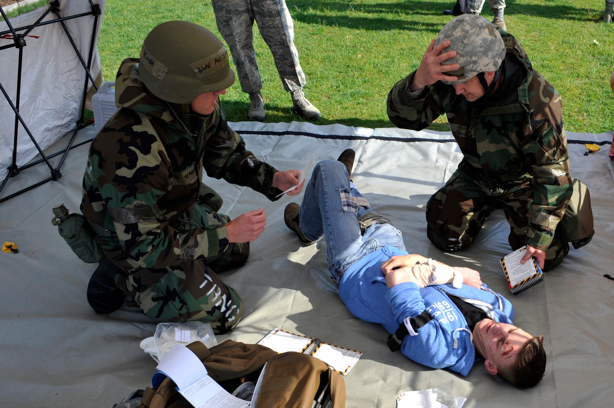 BUCKLEY AIR FORCE BASE, Colo. –  Lt Col. Shane Sullivan, right, 460th Space Wing chief of safety, and Airman 1st Class Jayce Yeager, 460th Civil Engineer Squadron, perform self-aid buddy care during the during an exercise, May 17, 2012.  Inspectors tested nearly 50 members of the 460th SW of skills they might need in an operational environment. (U.S. Air Force photo by Airman 1st Class Riley Johnson)