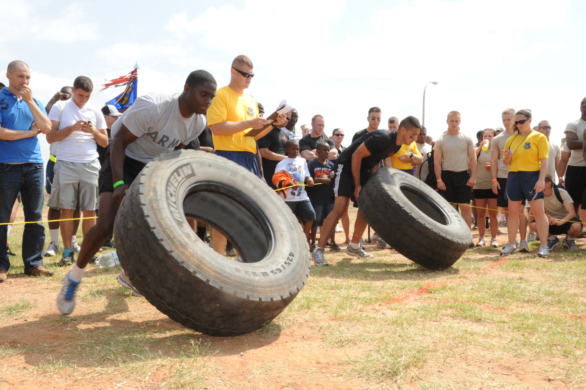 Airmen and Soldiers competed in the tire flip competition as their teammates cheered loudly. The tire weighed 179 pounds. (U.S. Air Force Photo/ Felton Joshua)