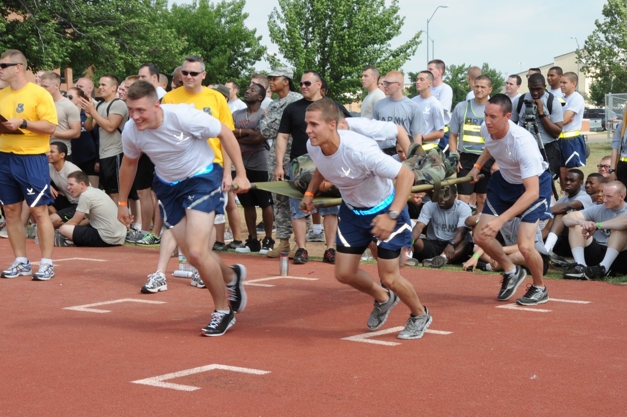 Airmen, Soldiers, Sailors and Marines celebrated Armed Forces Week at Sheppard Air Force Base by participating in the Joint Warrior Challenge May 19 at the base track. Airmen participated in the litter carry race with a 110-pound dummy as one of the four main events. (U.S. Air Force Photo/ Felton Joshua)