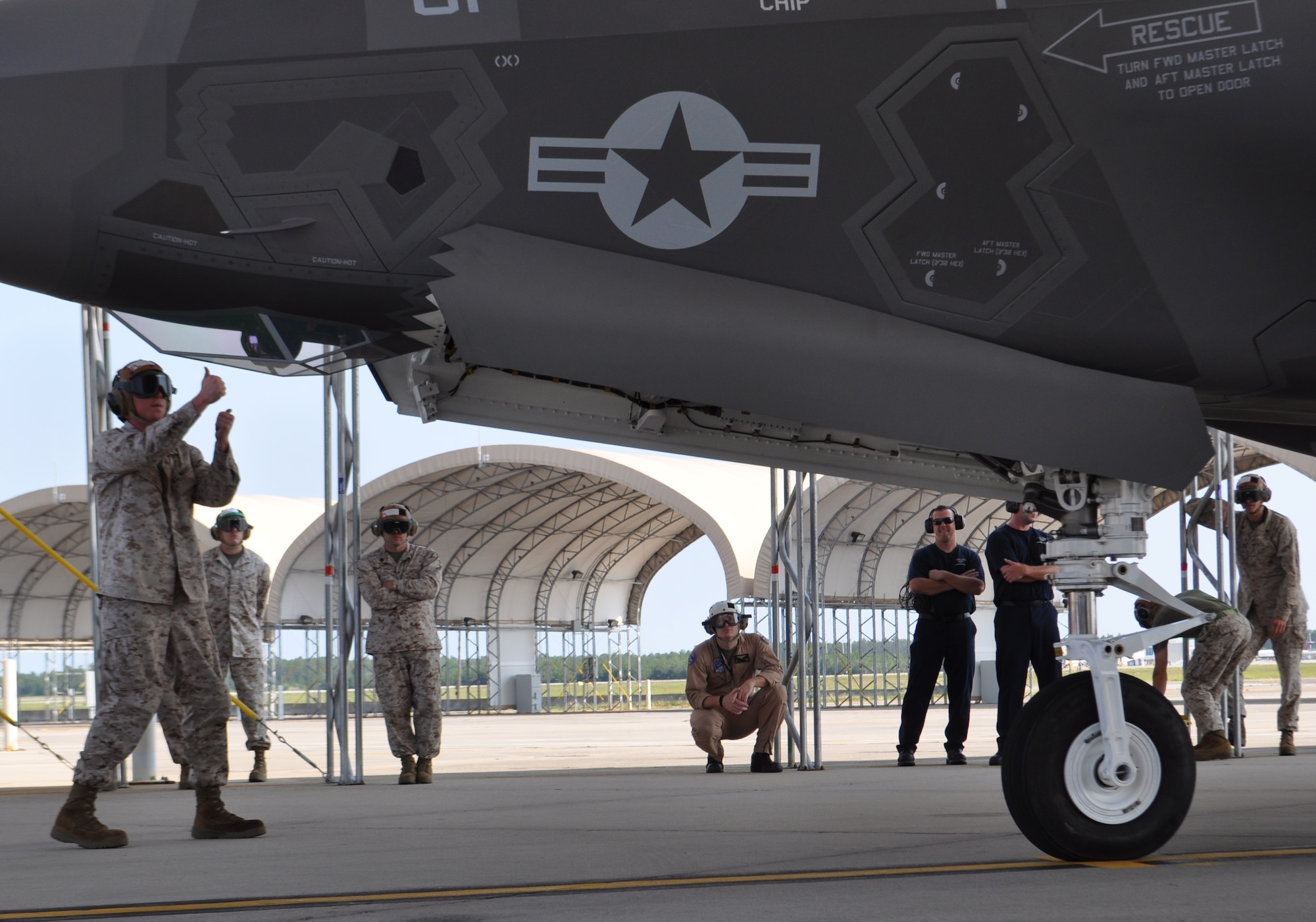 Marine Sgt. Eric Spence, a plane captain with Marine Fighter Attack Training Squadron-501, marshals the first F-35B sortie May 22. The goal for Marines was to start local area operations and conventional flights, beginning the process of gradually expanding the envelope to short takeoffs and vertical landings and more complex aerial training.The historic flight at Eglin Air Force Base was airborne during the Marine Corps' 100th year of aviation, two months after 2nd Marine Aircraft Wing officially introduced the service's fifth generation fighter to the world at the 33rd Fighter Wing. (U.S. Air Force photo/Maj. Karen Roganov)
