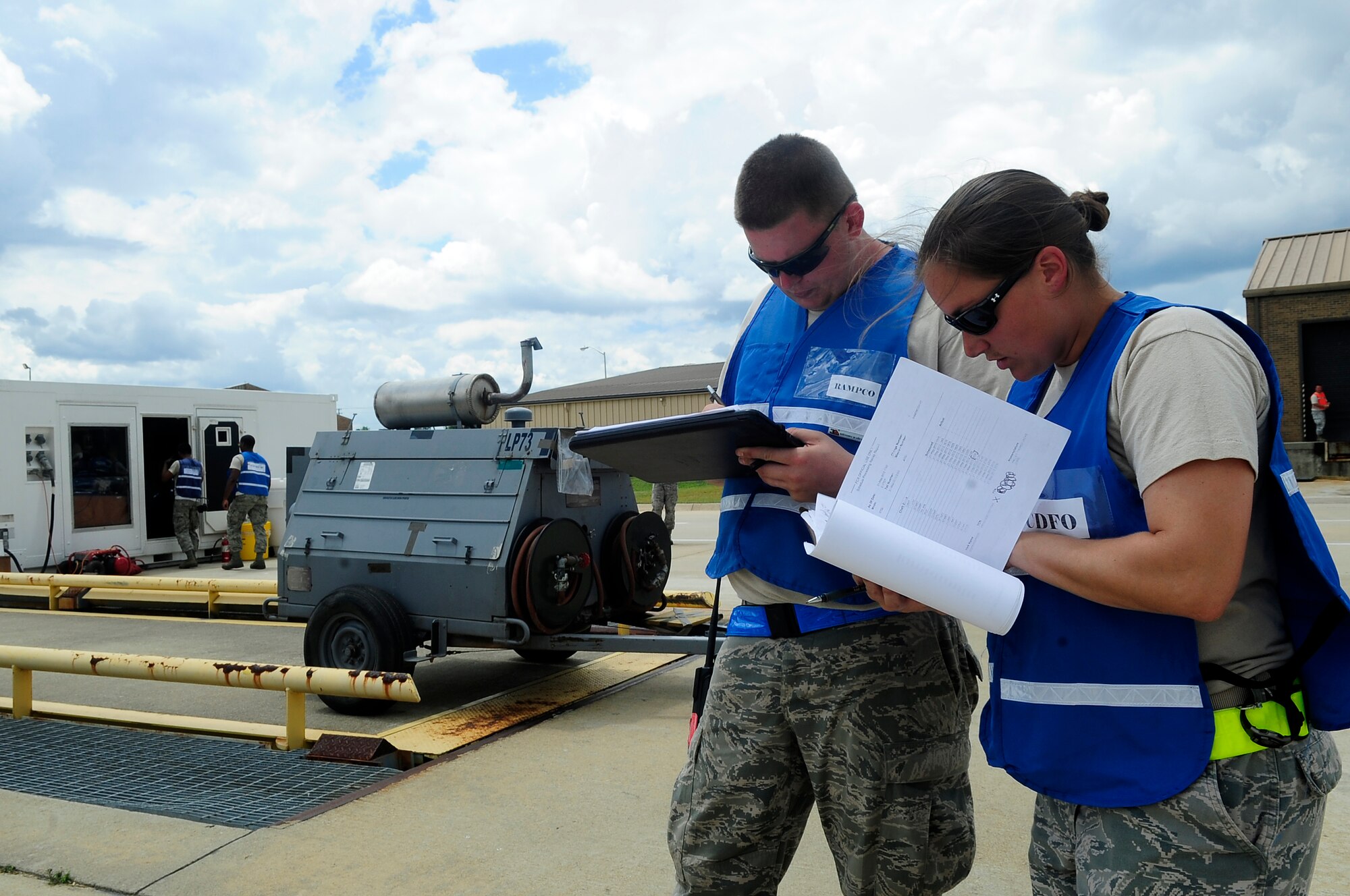 (Left) U.S. Air Force Staff Sgt. Richard Shelnutt, 20th Maintenance Operations Squadron deficiency analyst, and 1st Lt. Sara Ramirez, 20th Logistics Readiness Squadron officer in charge of distribution, relay cargo placement during an Operational Readiness Exercise at Shaw Air Force Base, S.C., May 21, 2012. AnORE evaluates the 20th Fighter Wing's ability to meet wartime and contingency tasks. (U.S. Air Force photo by Airman 1st Class Hunter Brady/Released)