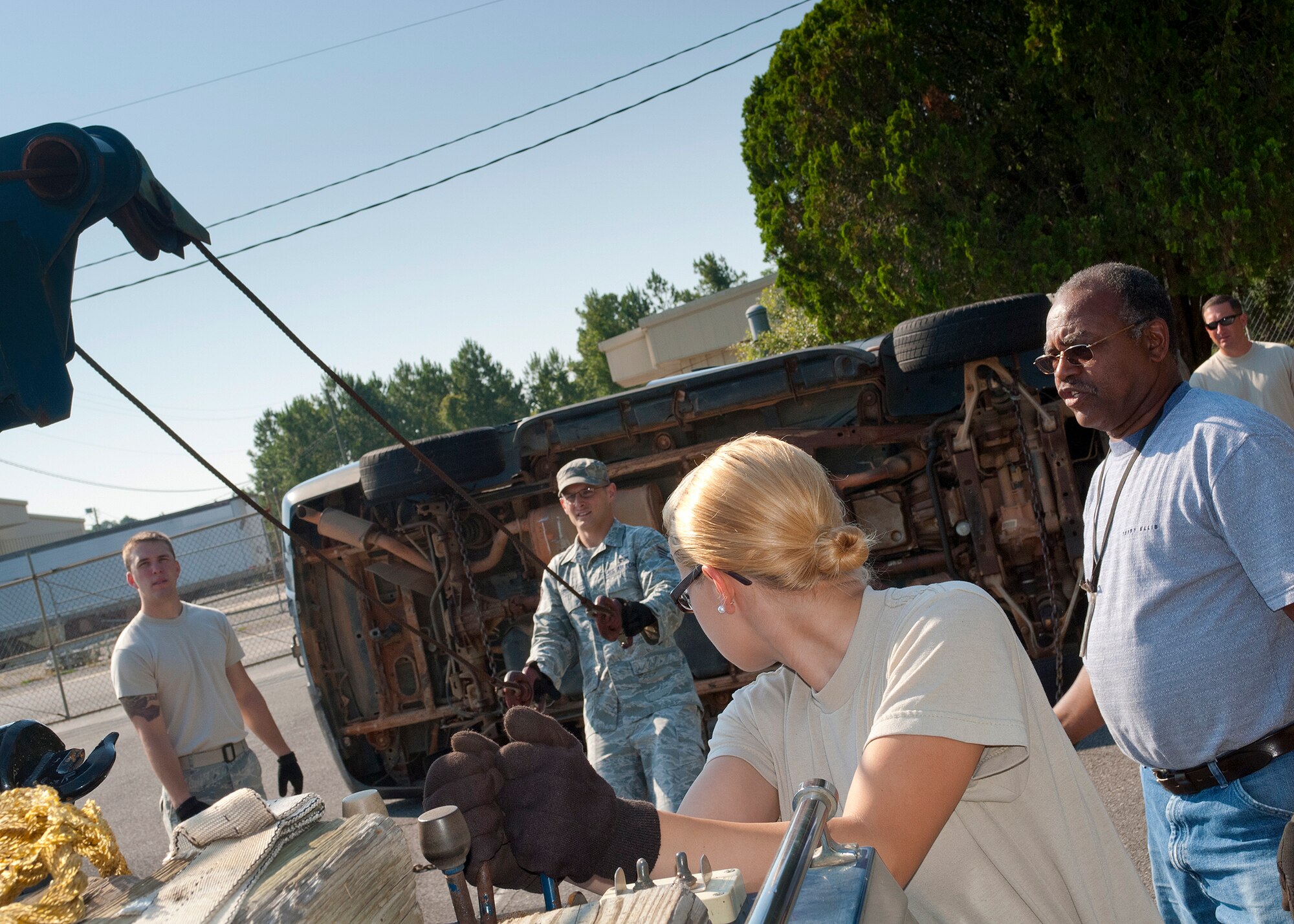 Airman Megan Rimes, of the 940th Logistic Readiness Squadron, operates the wrecker lift controls to overturn the vehicle, May 21 at Eglin Air Force Base, Fla. For the last three years, the 940th, a reserve unit from Beale AFB, Calif., travels to Eglin for annual training with the 96th Air Base Wing. (U.S. Air Force photo/Senior Airman Juan Martinez)
