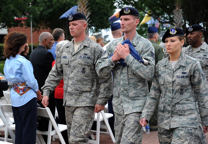 Airmen from the 628th Security Forces Squadron secure the flag during the “National Police Week” retreat ceremony May 18, 2012 at Joint Base Charleston, S.C. During National Police Week, Security Forces members honor law enforcement personnel who have fallen.  In 1962, President John F. Kennedy signed a proclamation which designated May 15th as Peace Officers Memorial Day and the week in which the date falls as Police Week.  (U.S. Air Force photo/Airman 1st Class Ashlee Galloway)