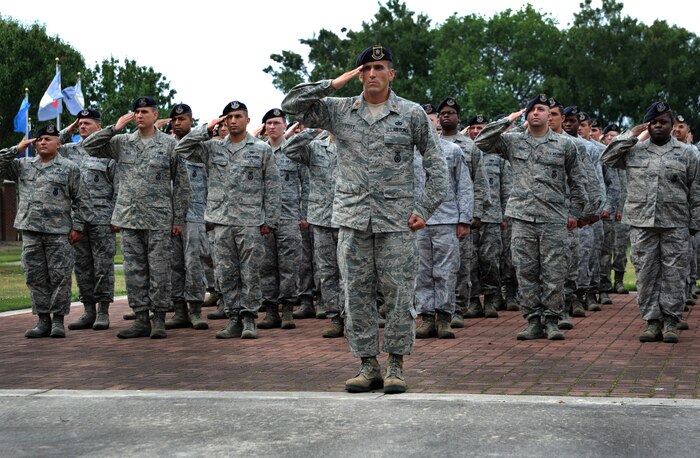 Airmen from the 628th Security Forces Squadron salute the flag during the “National Police Week” retreat ceremony May 18, 2012 at Joint Base Charleston, S.C. During National Police Week, Security Forces members honor law enforcement personnel who have fallen.  In 1962, President John F. Kennedy signed a proclamation which designated May 15th as Peace Officers Memorial Day and the week in which the date falls as Police Week.  (U.S. Air Force photo/Airman 1st Class Ashlee Galloway)