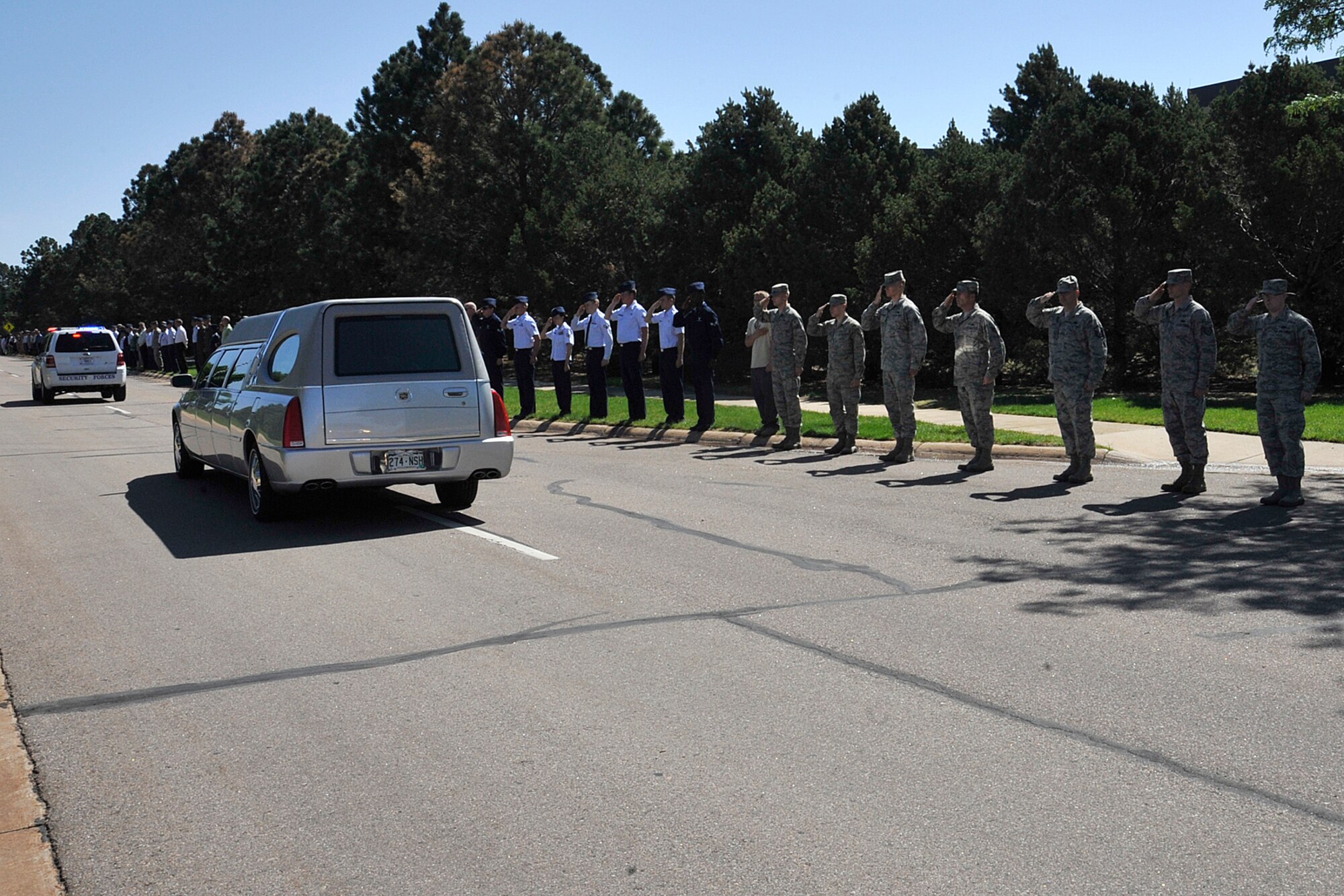 PETERSON AIR FORCE BASE, Colo. - Airmen and civilians line Peterson Boulevard May 21 to pay respect to Army 1st Lt. Alejo Thompson. Thompson was based at Fort Carson's 4th Infantry Division and was killed May 11 while serving in support of Operation Enduring Freedom in Parwan Province, Afghanistan. (U.S. Air Force photo/Dennis Howk)