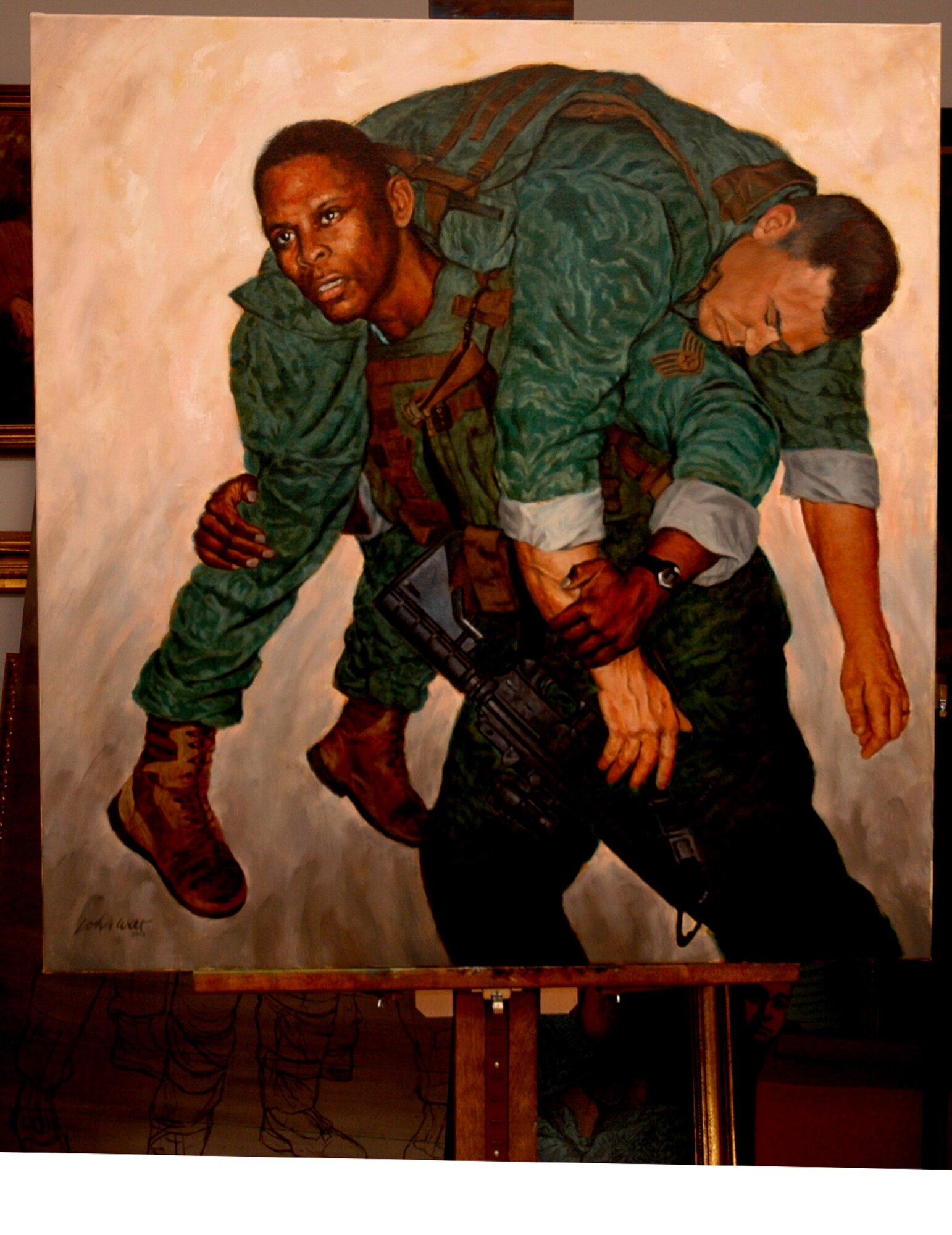 JOINT BASE McGUIRE-DIX-LAKEHURST, N.J.-- The painting titled "He Ain't Heavy," by Mr. John Witt of the Society of Illustrators, is displayed at the U.S. Air Force Expeditionary during the society's visit here, May 19. The painting includes Staff Sgt. Phillip Peterkins and Staff Sgt. Kyle Miller, of the 421st Combat Tactics Squadron, and was created using photos and sketches taken by Witt during a an early visit in November 2011. The painting will go on Air Force display tour later this year and will eventually become a part of the Expeditionary Center art collection.  (Courtesy Photo)