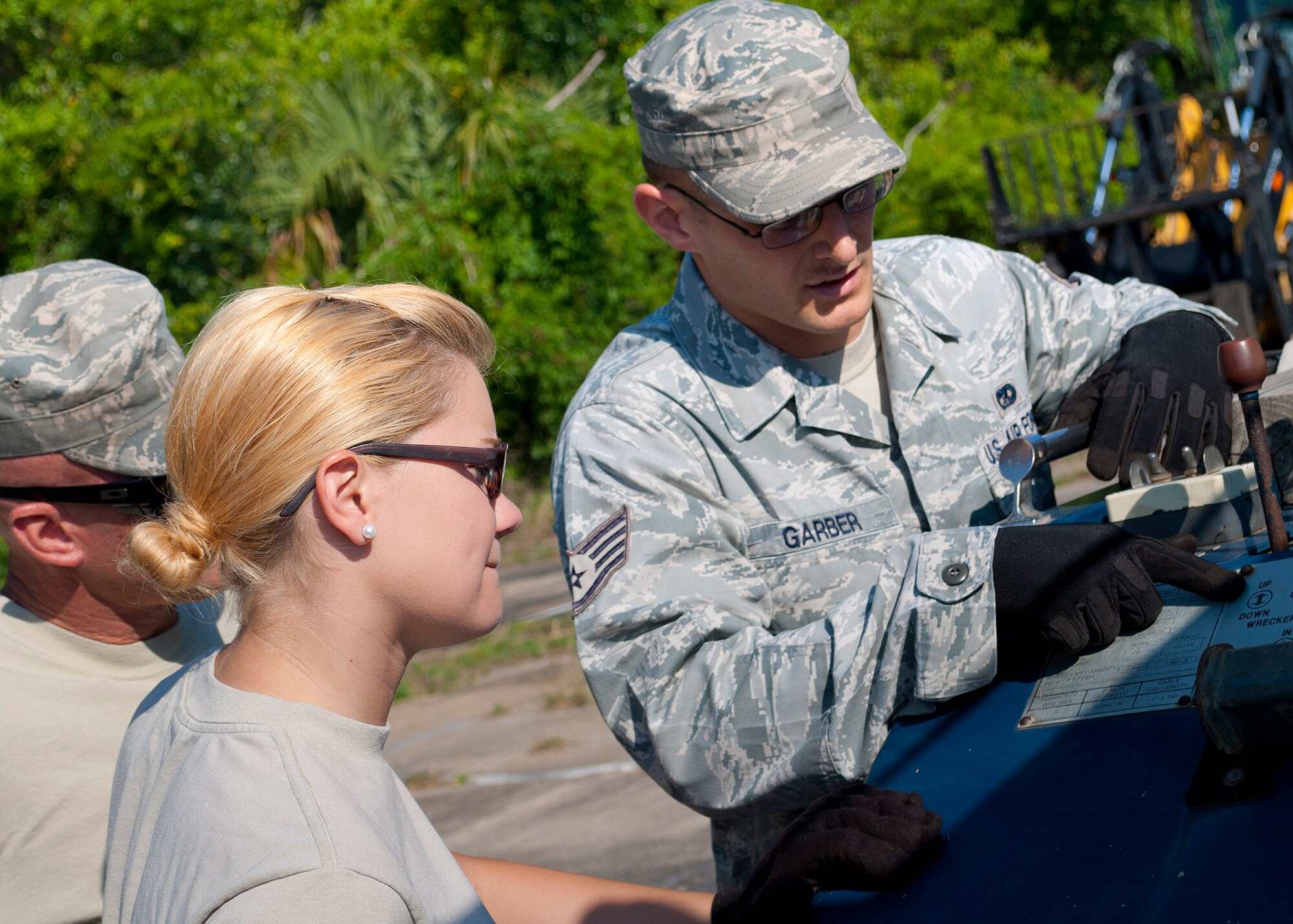 Staff Sgt. Patrick Garber, of the 96th Logistic Readiness Squadron, explains the wrecker lift controls to Airman Megan Rimes, of the 940th Logistic Readiness Squadron, May 21 at Eglin Air Force Base, Fla.  For the last three years, the 940th reserve unit from Beale AFB, Calif., travels to Eglin for annual training. (U.S. Air Force photo/Senior Airman Juan Martinez)
