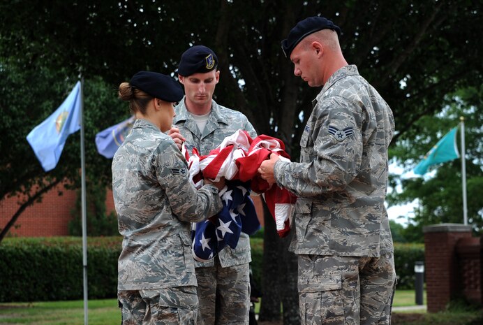 Airmen from the 628th Security Forces Squadron prepare to fold the flag during the “National Police Week” retreat ceremony May 18, 2012 at Joint Base Charleston, S.C. During National Police Week, Security Forces members honor law enforcement personnel who have fallen.  In 1962, President John F. Kennedy signed a proclamation which designated May 15th as Peace Officers Memorial Day and the week in which the date falls as Police Week. (U.S. Air Force photo/Airman 1st Class Ashlee Galloway)