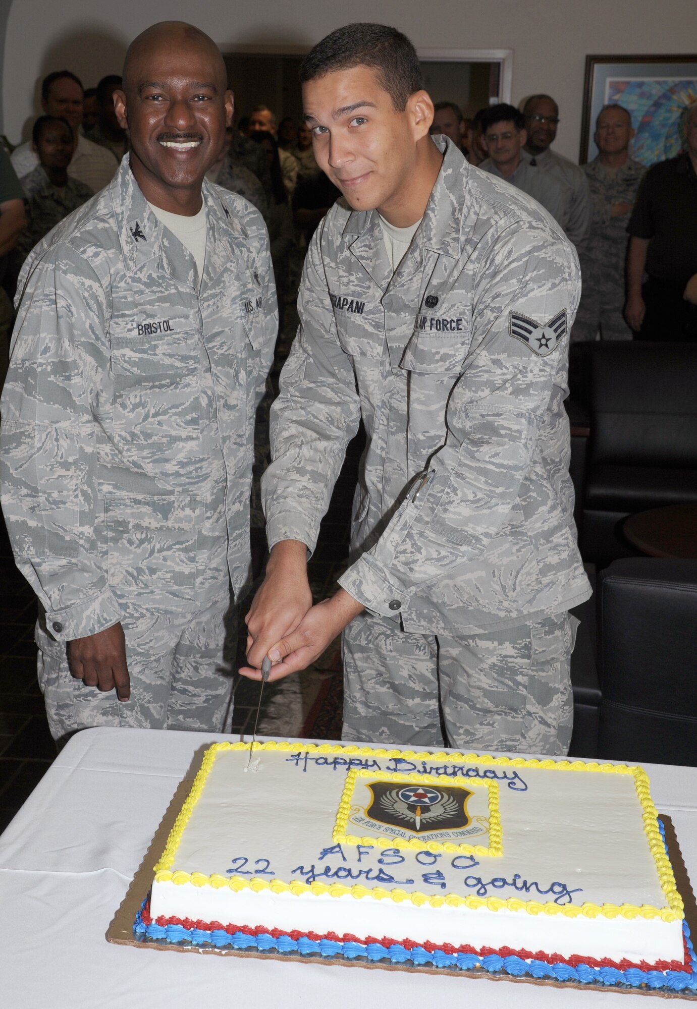 Colonel Wilfred Bristol, Air Force Special Operations Command's chaplain and oldest member, and Senior Airman Joseph Trapani, AFSOC's youngest member, cut the cake as the command celebrates its 22nd birthday.