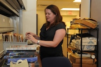 Ashley Armes, 12th Flying Training Wing historian, checks for historic documents in the history office files May 21 at Joint Base San Antonio-Randolph. (U.S. Air Force photo by Rich McFadden) 