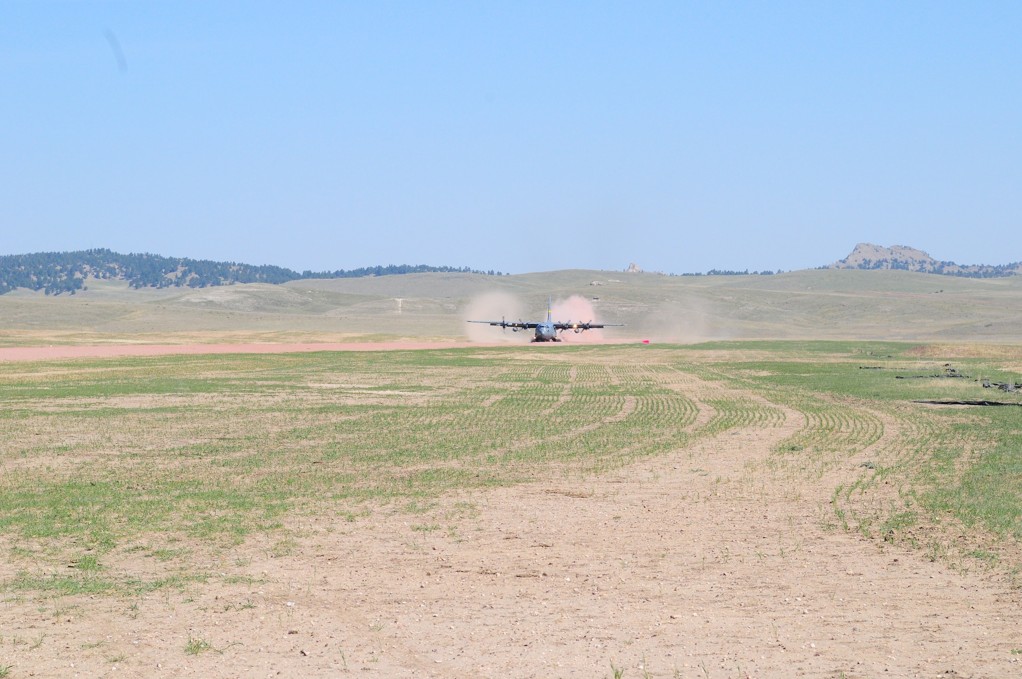 A Wyoming Air National Guard C-130 Hercules, assigned to the 153rd Airlift Wing, becomes the first to test the new Lt. Gen. Wright Tactical Airfield at the Camp Guernsey Joint Training Center's North Training Area, May 15, 2012. The airfield concept for Camp Guernsey was conceived 20 years ago and will provide aircrews real-world tactical training in coordination with ground combat forces. (Photo by Dewey Baars)