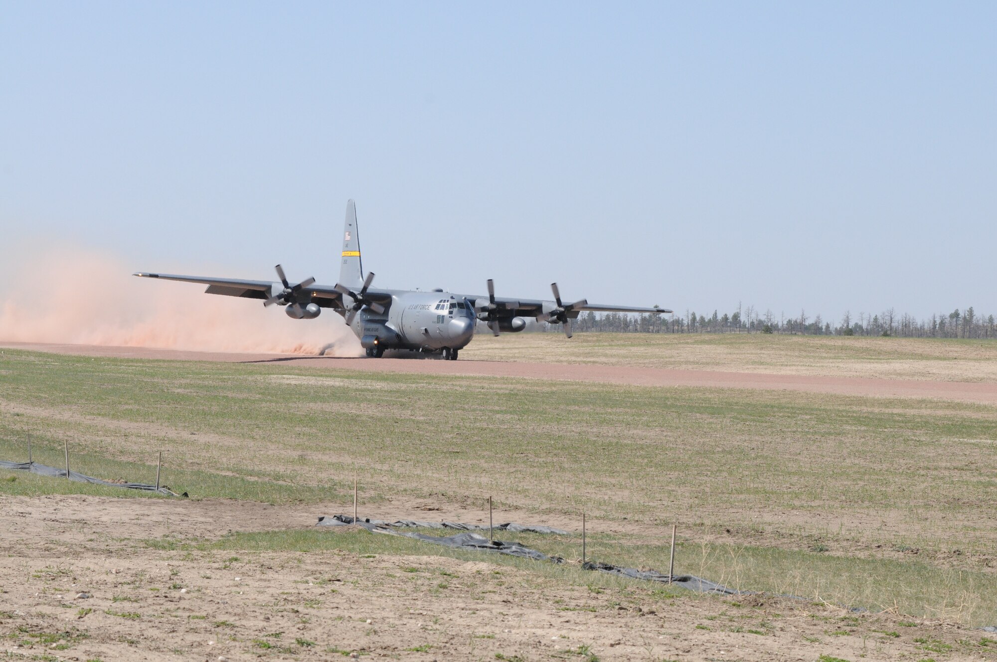A Wyoming Air National Guard C-130 Hercules, assigned to the 153rd Airlift Wing, becomes the first to test the new Lt. Gen. Wright Tactical Airfield at the Camp Guernsey Joint Training Center's North Training Area, May 15, 2012. The airfield concept for Camp Guernsey was conceived 20 years ago and will provide aircrews real-world tactical training in coordination with ground combat forces. (Photo by Dewey Baars)