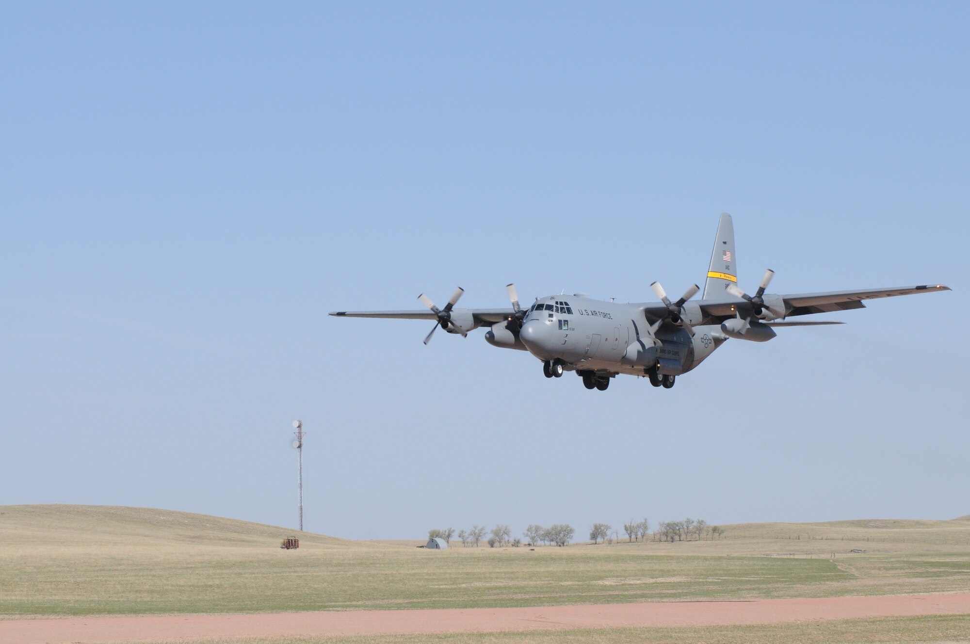 A Wyoming Air National Guard C-130 Hercules, assigned to the 153rd Airlift Wing, becomes the first to test the new Lt. Gen. Wright Tactical Airfield at the Camp Guernsey Joint Training Center's North Training Area, May 15, 2012. The airfield concept for Camp Guernsey was conceived 20 years ago and will provide aircrews real-world tactical training in coordination with ground combat forces. (Photo by Dewey Baars)