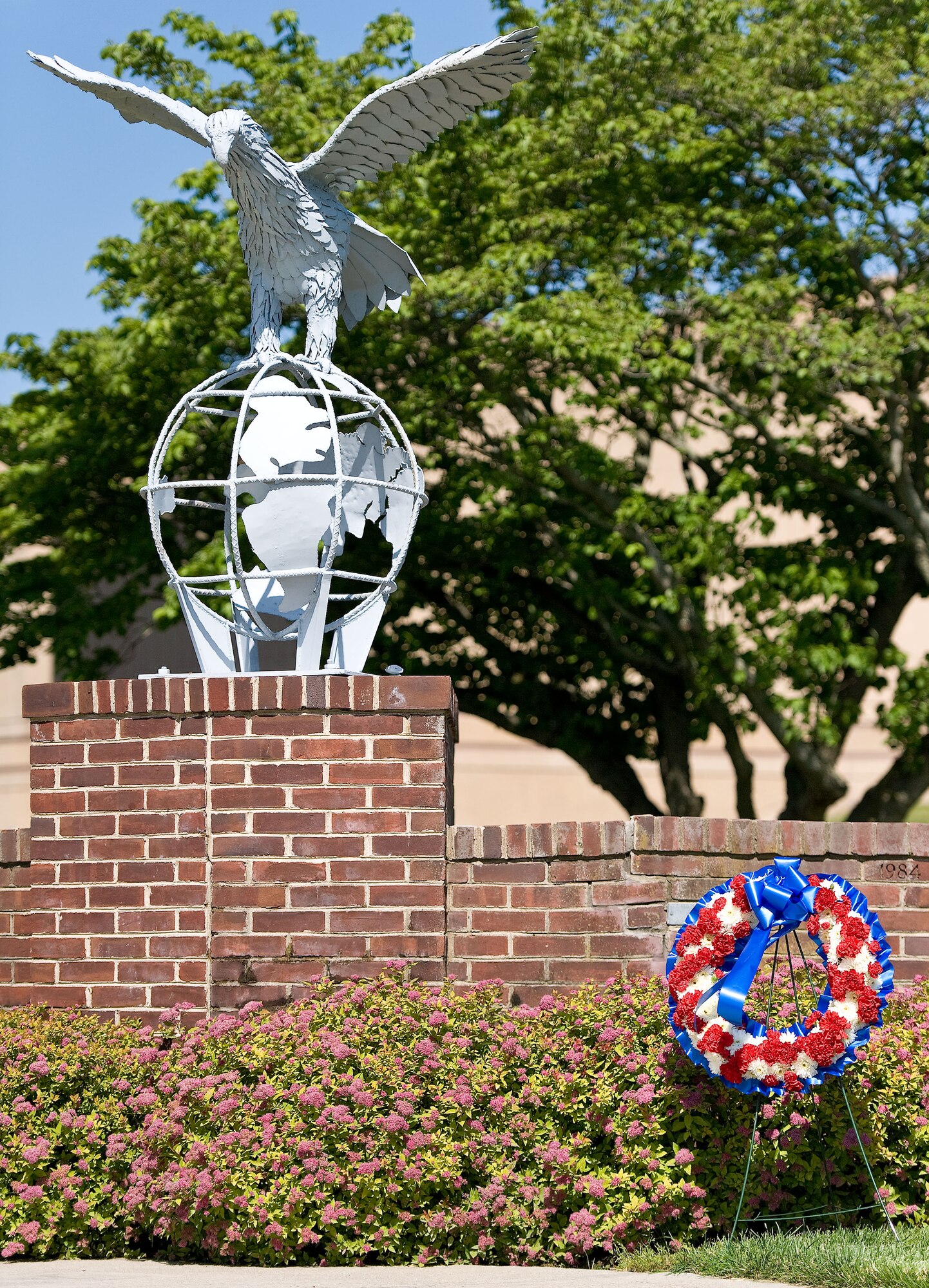 The wreath used in the National Police Week retreat ceremony, hosted by the 436th Security Forces Squadron, sits besides the Eagle statue May 19, 2012, at Dover Air Force Base, Del. The placing of the wreath honored both military and civilian law enforcement personnel who have paid the ultimate sacrifice in the line of duty. (U.S. Air Force photo by Roland Balik)
