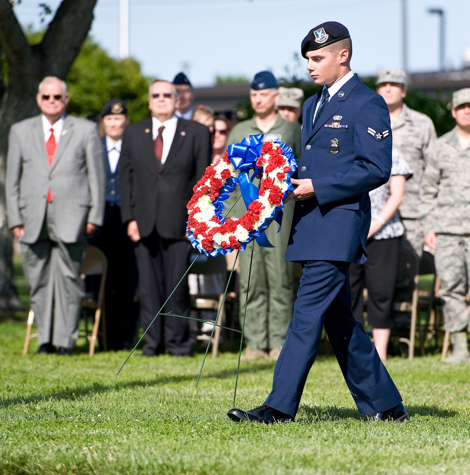 Airman 1st Class Caleb Wright of the 436th Security Forces Squadron carries a wreath during the National Police Week retreat ceremony May 18, 2012, at Dover Air Force Base, Del. The placing of the wreath honored both military and civilian law enforcement personnel who have paid the ultimate sacrifice in the line of duty. (U.S. Air Force photo by Roland Balik)

