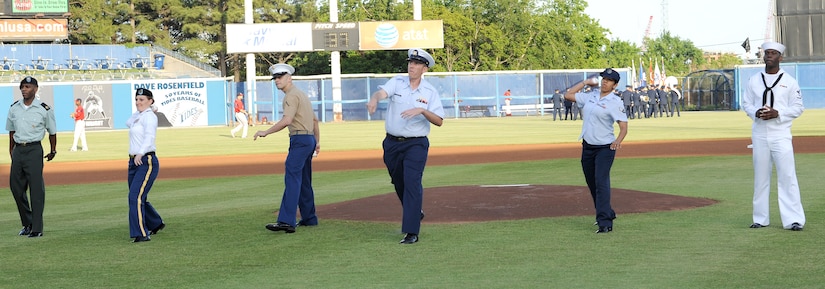 Superior performers from each military branch of service throw the first pitches at the Norfolk Tides’ 17th annual Armed Forces Night at Harbor Park Stadium in Norfolk Va., May 19, 2012. The Tides wore digital camouflage print uniforms during the game against the Pawtucket Red Sox to honor Service members from all branches of the Armed Forces. (U.S. Air Force photo by Airman 1st Class Teresa Cleveland/Released)