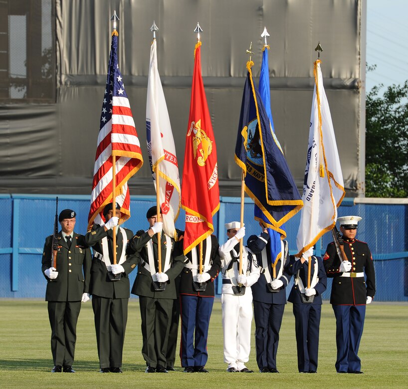 The U.S. Joint Service Color Guard presents the colors during the opening ceremony of the Norfolk Tides’ 17th annual Armed Forces Night at the Harbor Park Stadium in Norfolk, Va., May 19, 2012. Events included a performance of U.S. military anthems and the National Anthem by the U.S. Air Force Heritage of America Band, as well as first pitches thrown by Service members from each branch of the Armed Forces. (U.S. Air Force photo by Airman 1st Class Teresa Cleveland/Released)
