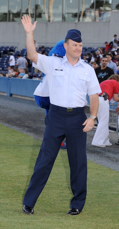 U.S. Air Force Lt. Col. Christopher Wegner, 633rd Contracting Squadron commander, waves to the crowd during the opening ceremony of the Norfolk Tides’ 17th annual Armed Forces Night at the Harbor Park Stadium in Norfolk, Va., May 19, 2012. The event included a presentation of the colors by the U.S. Joint Service Color Guard and first pitches by Service members from each branch of the Armed Forces. (U.S. Air Force photo by Airman 1st Class Teresa Cleveland/Released)