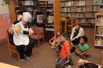 Janet Trevino, 902nd Force Support Squadron librarian, reads stories to the children from the Joint Base San Antonio-Randolph Child Development Center May 18 at the JBSA-Randolph library for the kick off of the summer reading program.  (U.S. Air Force photo by Rich McFadden) 