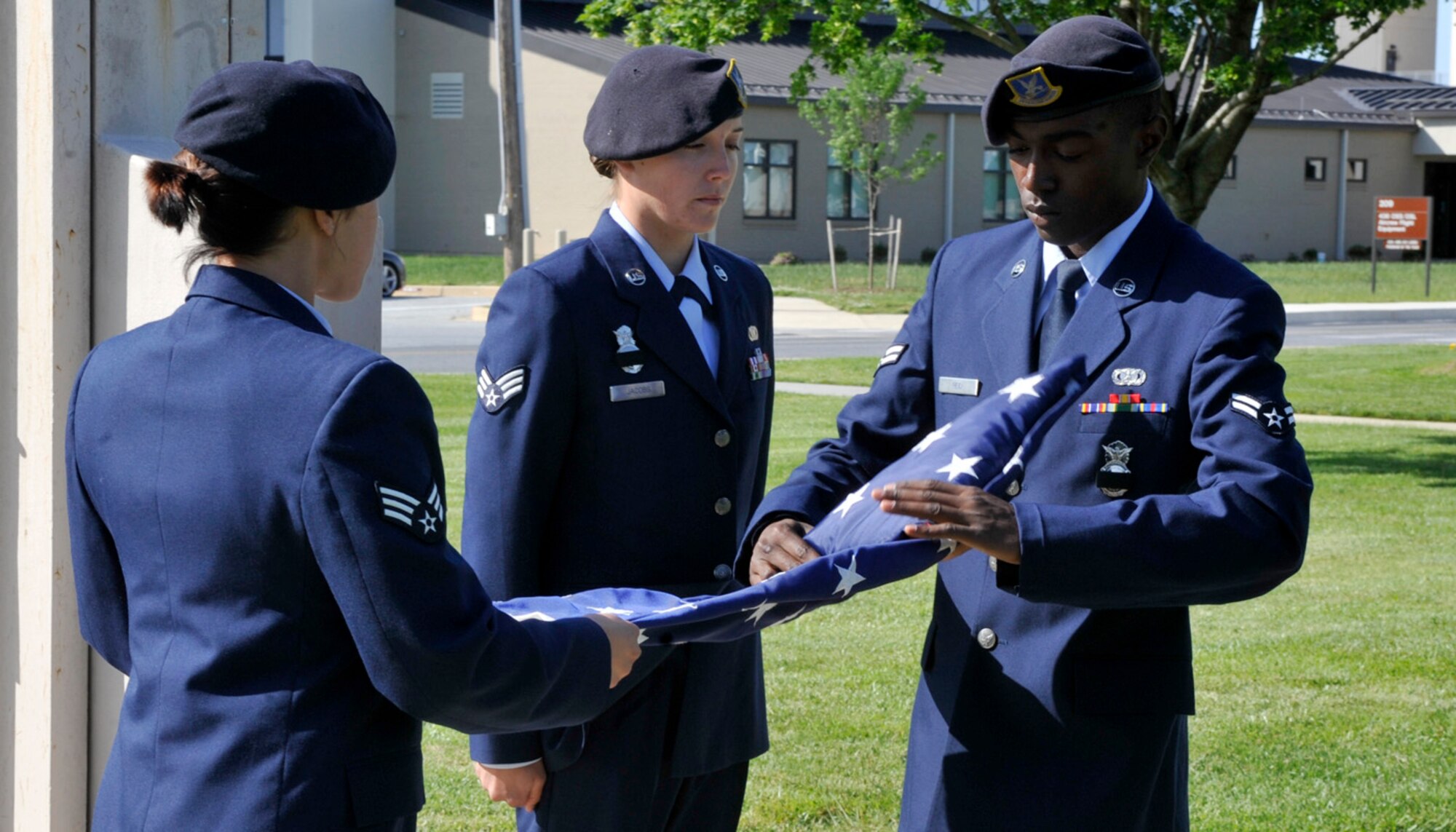 Airman 1st Class Preston Reid, 436th Security Forces Squadron, folds the flag during a retreat ceremony May 18, 2012, on Dover Air Force Base, Del. The retreat was to commemorate National Police Week. (U.S. Air Force photo by Tech. Sgt. Chuck Walker)