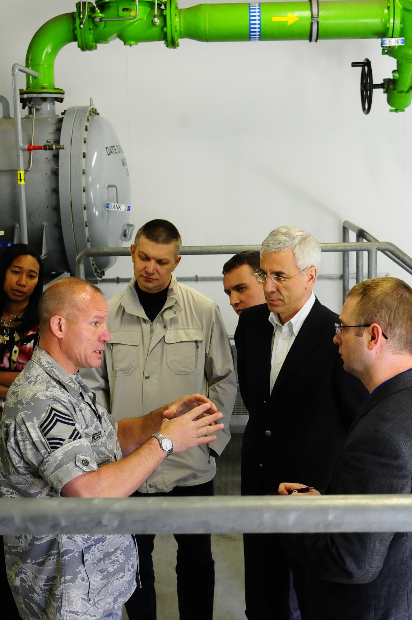 Chief Master Sgt. Howard Heisey, 86th Logistics Readiness Squadron fuels manager, gives a tour to Russian delegates for a bilateral fuels engagement here May 17. The delegates received a tour of the flightline, to include the facilities where the Central European Pipeline System enters the base. (U.S. Air Force photo/Airman 1st Class Hailey Haux) 