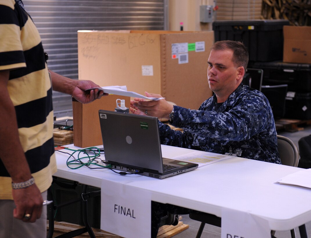 U.S. Navy Petty Officer 1st Class Michael Hill verifies deployment readiness of Joint Task Force Civil Support personnel during a semi-annual, personnel-readiness exercise at Fort Eustis, Va., May 10-11, 2012. JTF-CS commands and controls designated Department of Defense forces to assist local, state, federal and tribal partners in saving lives, preventing further injury and providing critical support to enable community recovery. (U.S. Army photo by Sgt. Ida Irby/Released)