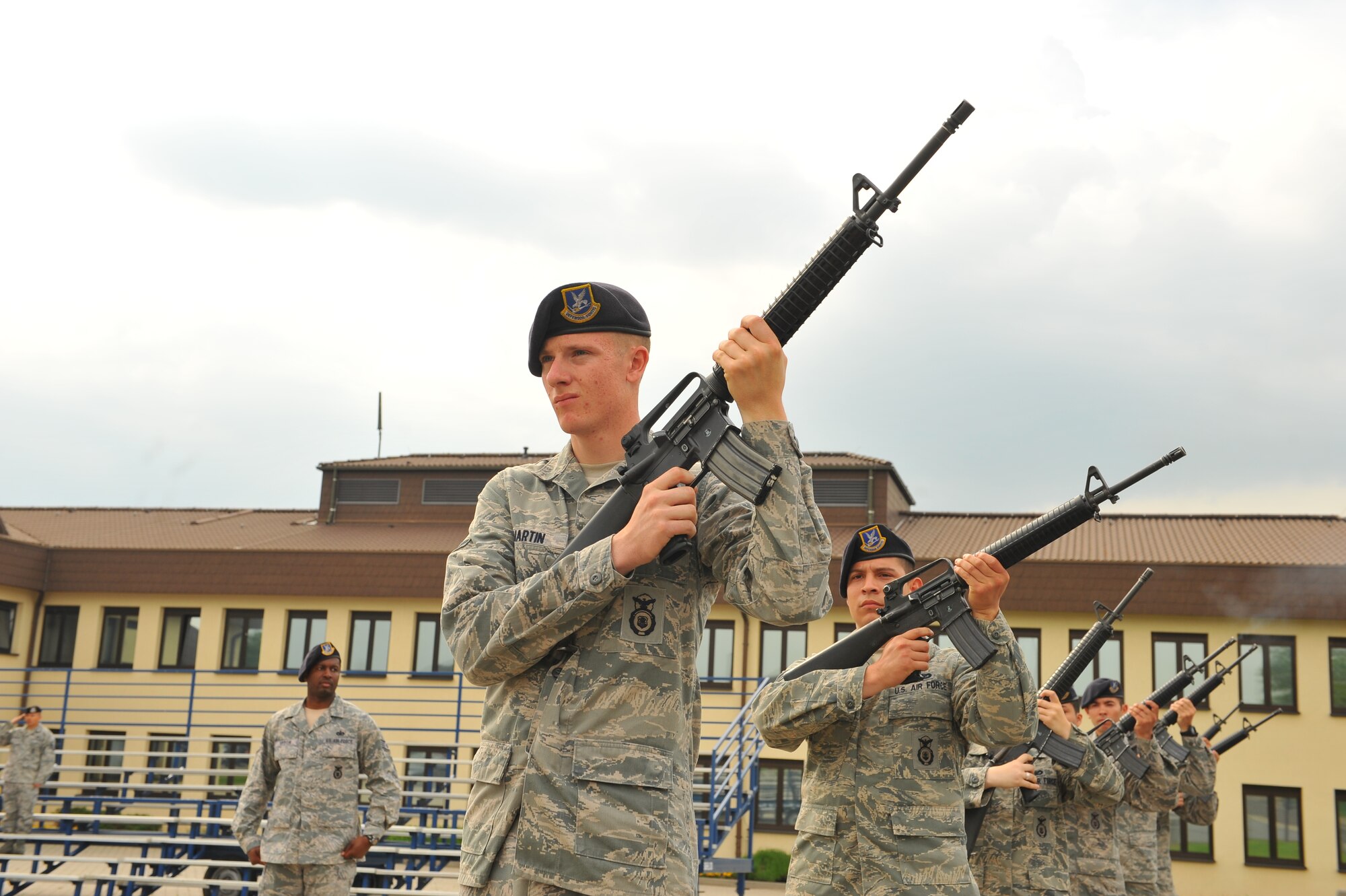 SPANGDAHLEM AIR BASE, Germany – Airman 1st Class Christopher Martin, front, 52nd Security Forces Squadron patrolman, and fellow fire-team members perform a 21-gun salute during the National Police Week retreat ceremony outside the wing headquarters building here May 21. The ceremony consisted of the playing of retreat music followed by the German and American national anthems and the lowering of each country’s flag. The ceremony closes National Police Week by honoring law enforcement members who gave their life for the safety and protection of others. (U.S. Air Force photo by Airman 1st Class Dillon Davis/Released)