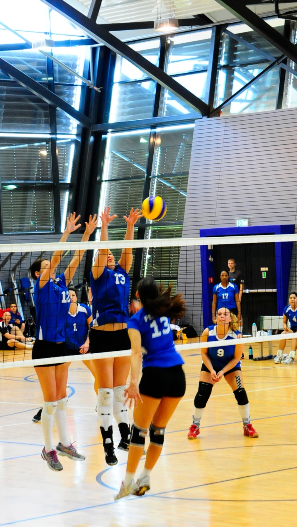 Members of the Ramstein women’s volleyball team jump to block a spiked ball from a member of the Aviano women’s team during the 2012 U.S. Forces in Europe Volleyball Championship held at the South Side fitness center here May 20. Aviano came out on top during the championship match, winning the championship title. (U.S. Air Force photo/Airman 1st Class Hailey Haux)
