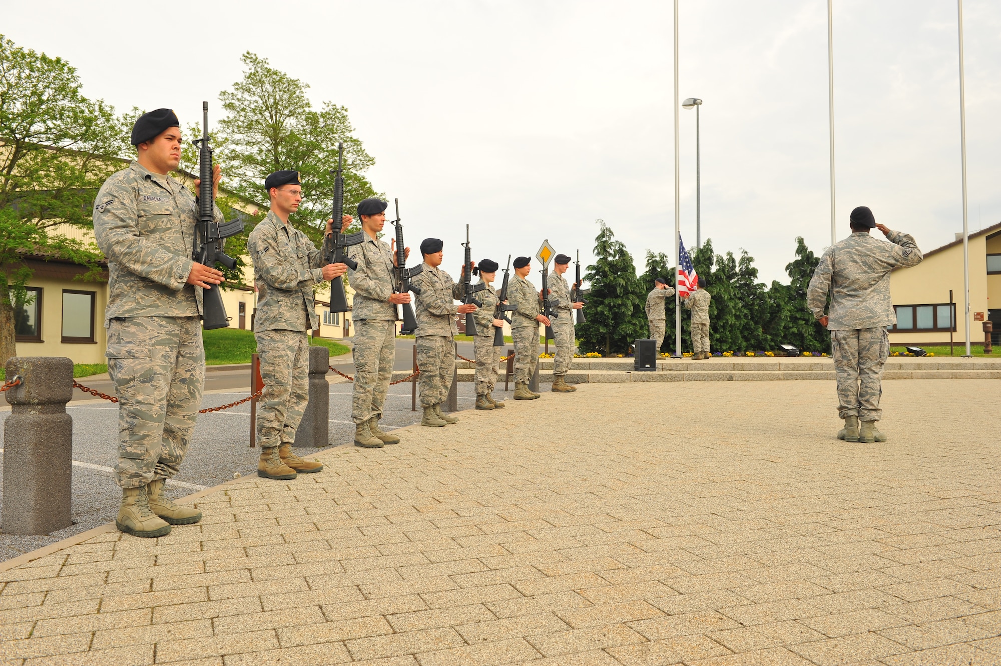 SPANGDAHLEM AIR BASE, Germany – Airmen from the 52nd Security Forces Squadron stand in a fire-team formation during the National Police Week retreat ceremony outside the wing headquarters building here May 21. The ceremony consisted of the playing of retreat followed by the German and American national anthems and the lowering of each country’s flag. The ceremony closes National Police Week by honoring law enforcement members who gave their life for the safety and protection of others. (U.S. Air Force photo by Airman 1st Class Dillon Davis/Released)