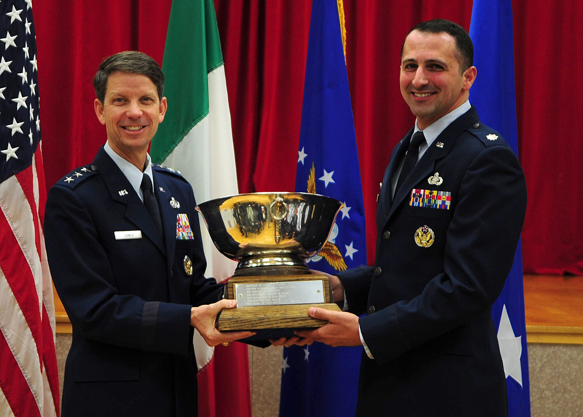 Lt. Col. Thomas Angelo (right), 31st Force Support Squadron commander, accepts the 2011 Air Force's General Curtis E. LeMay Award on behalf of his unit from Lt. Gen. Darrell D. Jones (left), deputy chief of staff for manpower, personnel, and services, May 21 at Aviano Air Base, Italy. The award is given to the best services organization at a base with at least 6,000 personnel and it is based on an evaluation process of the programs offered by the squadron and results from the Air Force Services Customer Feedback Survey.  (U.S. Air Force Photo by Staff Sgt. Evelyn Chavez)