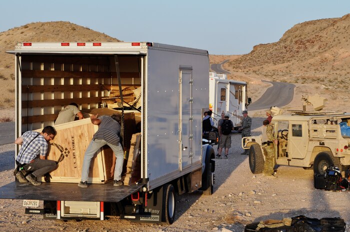As the sun sets, a production crew loads props and equipment used in a film production shoot May 17, 2012 at Nellis Air Force Base, Nev. The crew, filming on behalf of Digital Domain Productions for the Air Force Recruiting Service, worked alongside several units at Nellis for almost a week shooting footage to be used in a recruiting simulator ride. Digital Domain is a major Hollywood visual effects company that specializes in action productions, and is helping the recruiting service bring the first-person experience of participating in an Air Force mission to the public. (U.S. Air Force photo by Benjamin Newell, Released)