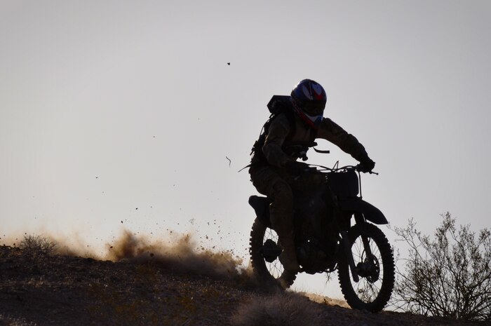 Devin Blackwell, stunt performer, hurtles down a hill on a desert dirt bike during filming for an Air Force Recruiting Service simulator project May 17, 2012, at Nellis Air Force Base, Nev. Blackwell wore a camera rig that recorded footage and motion information which will be turned into a first person view in the simulator. The simulator will be used to help members of the public personally experience the roles and missions the Air Force carries out in a dramatized but representative way. (U.S. Air Force photo by Benjamin Newell, Released)