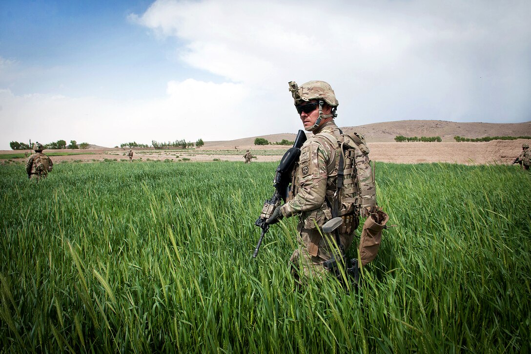 U.S. Army Sgt. Ricky Muenzer, center, patrols through agricultural land in Afghanistan's Ghazni province, May 17, 2012. Muenzer is assigned to the 82nd Airborne Division’s 3rd Squadron, 73rd Cavalry Regiment, 1st Brigade Combat Team.