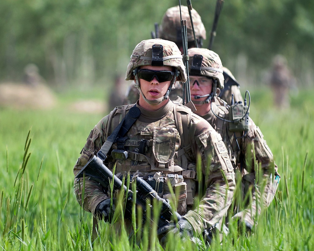 U.S. Army Pvt. Michael Phillips, front, leads fellow paratroopers through an agricultural field in Afghanistan's Ghazni province, May 17, 2012. Phillips is assigned to the 82nd Airborne Division’s 3rd Squadron, 73rd Cavalry Regiment, 1st Brigade Combat Team.