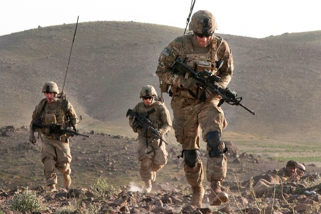 U.S. Army 2nd Lt. Daniel Miller rushes with fellow paratroopers to a hilltop to direct the elements of his platoon during a firefight in Afghanistan's Ghazni province, May 17, 2012. Miller, a platoon leader, is assigned to the 82nd Airborne Division’s 3rd Squadron, 73rd Cavalry Regiment, 1st Brigade Combat Team.