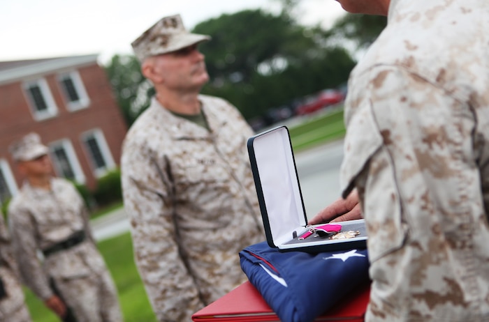 The Legion of Merit Medal was awarded to Col. Kenneth D. Enzor during his retirement ceremony aboard Camp Lejeune, N.C., May 23, 2012. Enzor began his military career in 1974 when he enlisted in the U.S. Army. He commissioned as a second lieutenant in the Marine Corps in 1982. His other decorations include the Defense Meritorious Service Medal, Meritorious Service Medal and the Navy and Marine Corps Commendation Medal. (U.S. Marine Corps photo by Staff Sgt. Justin J. Shemanski)