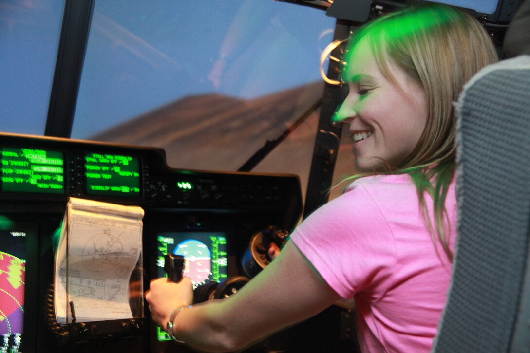 Ashley Nartins, a military spouse, flies the KC-130J flight simulator as a part of the Marine Aerial Refueler Transport Squadron 252 Jane Wayne day aboard Marine Corps Air Station Cherry Point, May 23. Approximately 30 women showed up for the event and participated in different stations where they looked at Marine Corps issue night vision goggles, flew the KC-130J simualtor and learned Marine Corps Martial Arts Program moves throughout the day.