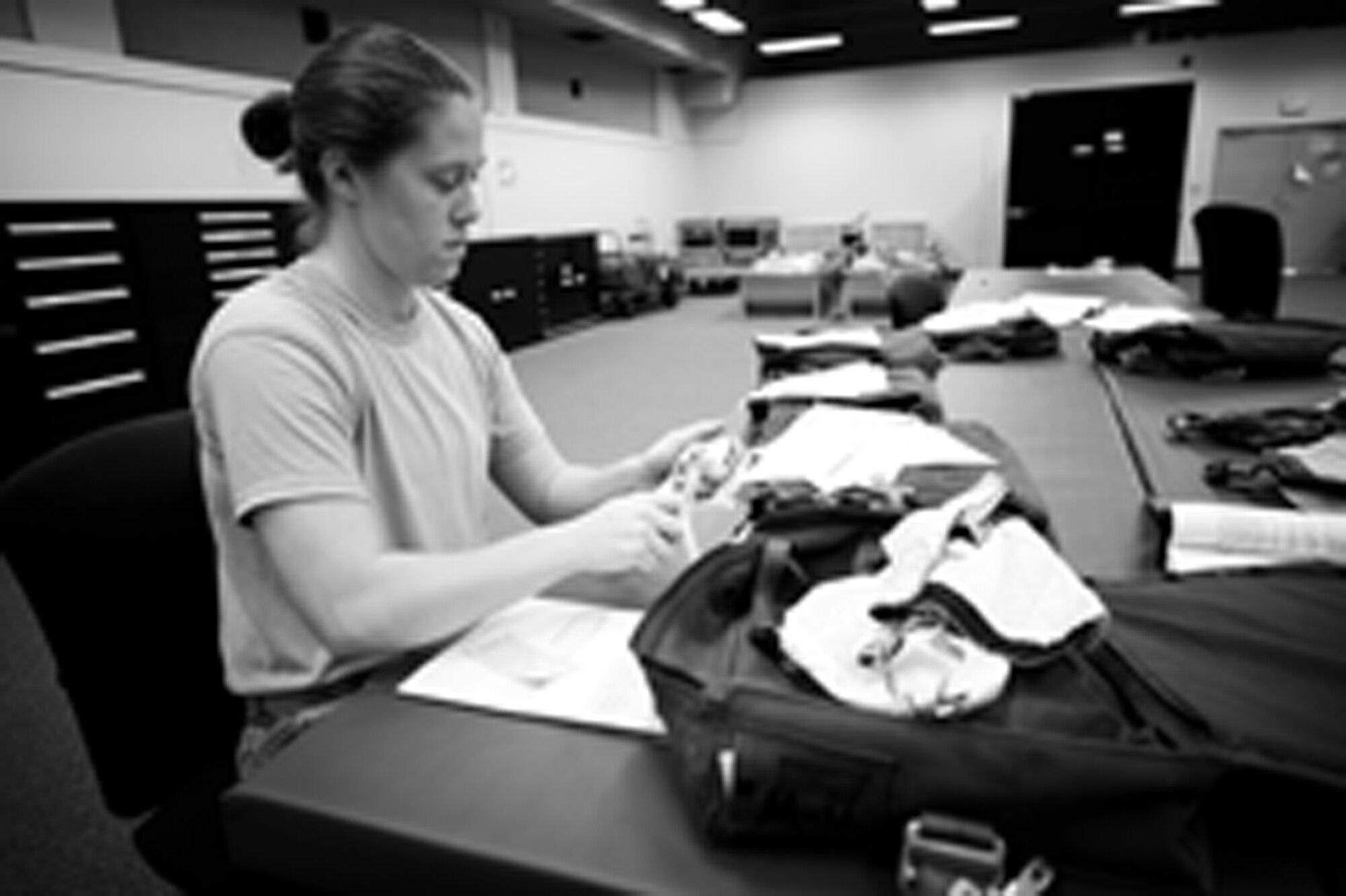 YOKOTA AIR BASE, Japan -- Airman 1st Class Amber Walz, 374th Operations Support Squadron aircrew flight equipment craftsman, inspects the survival components of a parachute survival kit at Yokota Air Base, Japan, May 21, 2012. The survival kit contains components that assist aircrew members following an emergency evacuation from an aircraft. (U.S. Air Force photo by Airman 1st Class Krystal M. Garrett) 