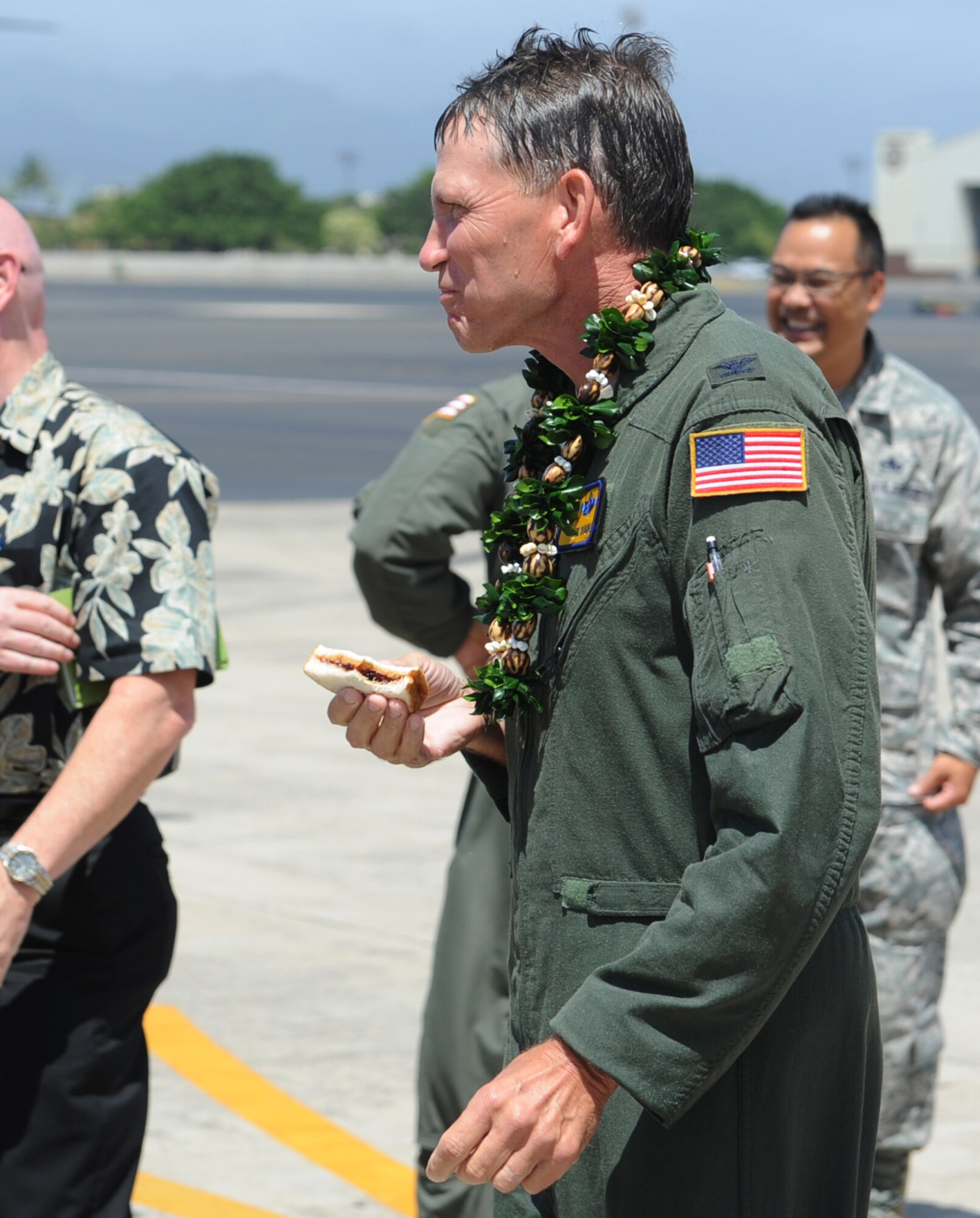 Col. Joe Dague, 15th Wing vice commander, eats a peanut
butter and jelly sandwich, his trademark meal, after landing at Joint Base
Pearl Harbor-Hickam, Hawaii, during the celebration of  his "fini flight"
May 23. Dague, a master navigator with more than 2,900 flight hours, has
been the 15th Wing vice commander since June 2010. (U.S. Air Force photo by
Staff Sgt. Nathan Allen)