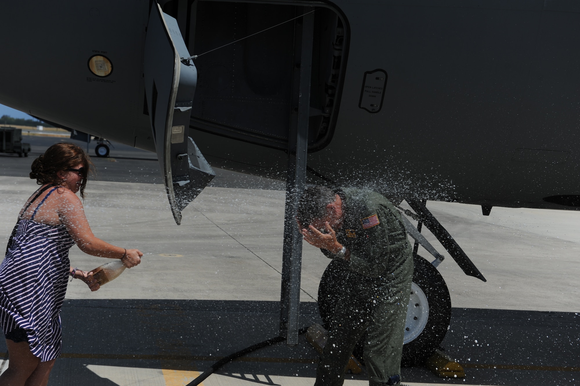 Family members of Col. Joe Dague, 15th Wing vice
commander, douse him with champagne at Joint Base Pearl Harbor-Hickam,
Hawaii, to celebrate his "fini flight" May 23. Dague, a master navigator
with more than 2,900 flight hours, has been the 15th Wing vice commander
since June 2010. (U.S. Air Force photo by Staff Sgt. Nathan Allen)