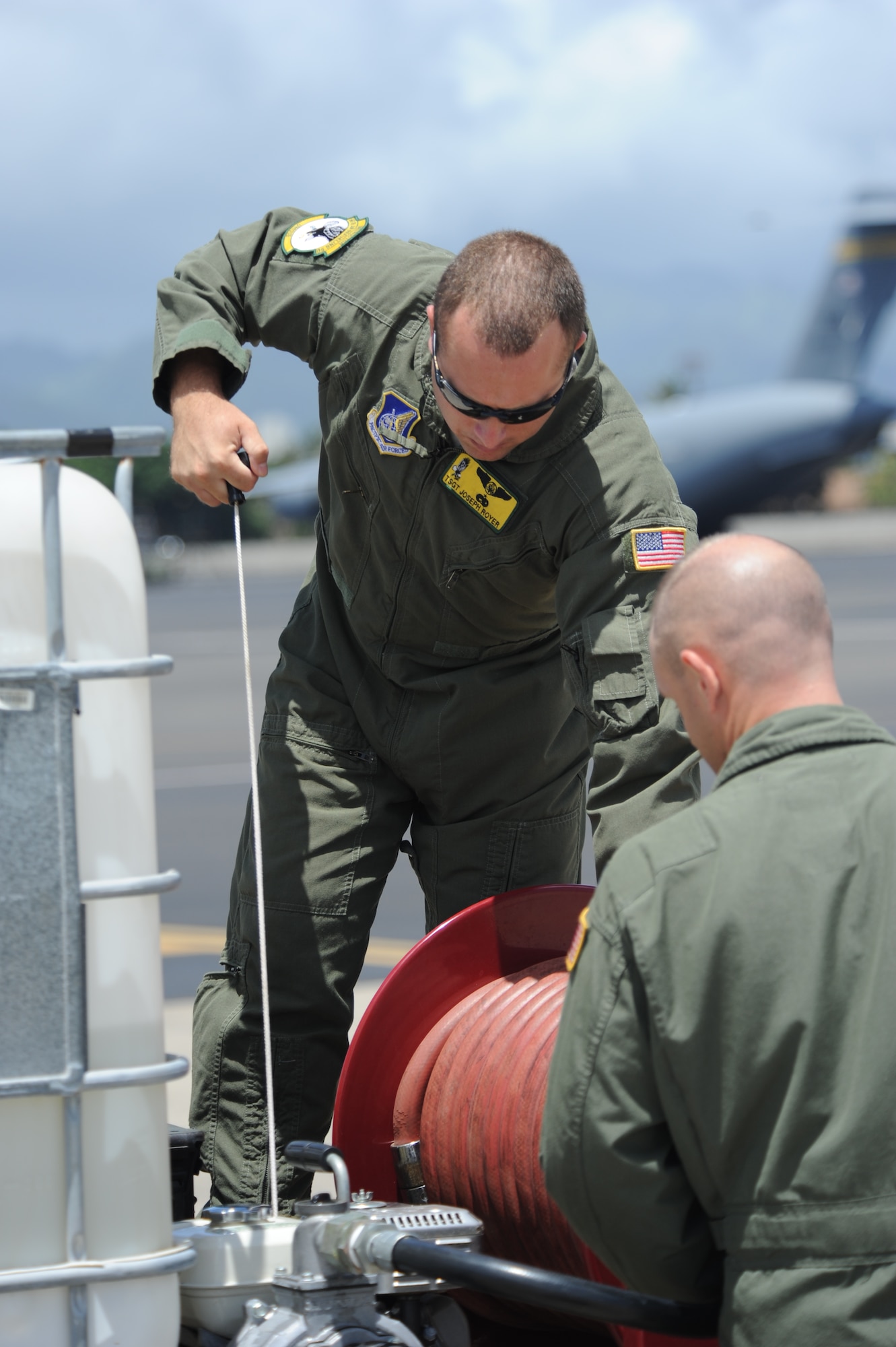 Tech. Sgt. Joseph Royer, 96th Air Refueling Squadron,
checks the engine of a water pump in preparation to douse Col. Joe Dague,
15th Wing vice commander, upon his landing at Joint Base Pearl
Harbor-Hickam, Hawaii, for his "fini flight" May 23.  Dague, a master
navigator with more than 2,900 flight hours, has been the 15th Wing vice
commander since June 2010. (U.S. Air Force photo by Capt. Ben Sakrisson)
