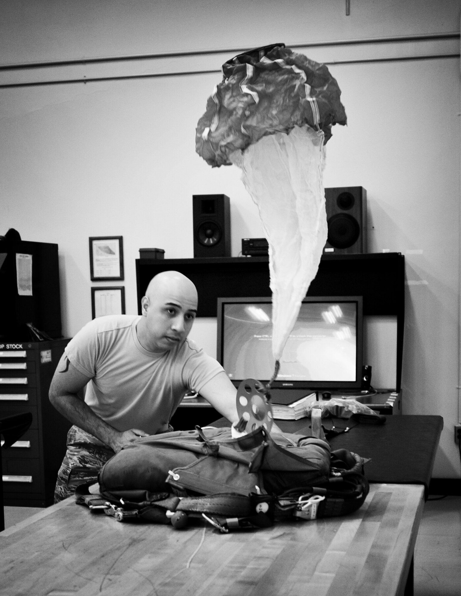 YOKOTA AIR BASE, Japan -- Senior Airman Phillip Rodriguez, 374th Operations Support Squadron aircrew flight equipment journeyman, tests a parachute after repairs at Yokota Air Base, Japan, May 21, 2012. Parachutes are inspected, repaired and packed for the safety of aircrew members to use in an emergency. (U.S. Air Force photo by Airman 1st Class Krystal M. Garrett) 