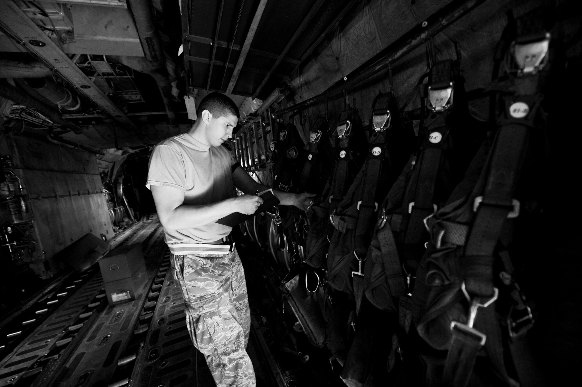 YOKOTA AIR BASE, Japan -- Staff Sgt. Brock Atchley, 374th Operations Support Squadron aircrew flight equipment craftsman, inspects dates on parachutes at Yokota Air Base, Japan, May 21, 2012. The parachutes are stored on aircraft and used during emergency situations. (U.S. Air Force photo by Airman 1st Class Krystal M. Garrett) 