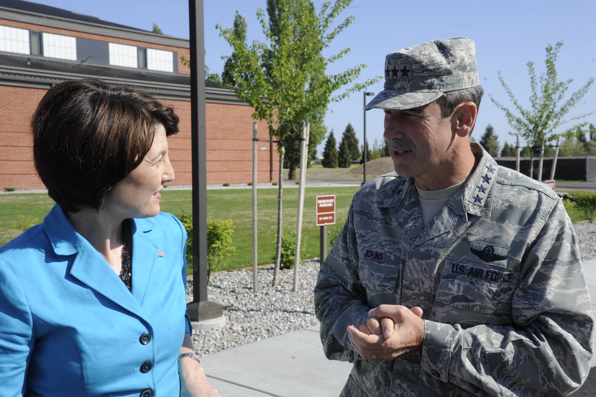 Cathy McMorris Rogers, U.S. Representative for the 5th District of Washington, and Gen. Raymond Johns Jr., Air Mobility Command commander, discuss the new fitness center at the ribbon cutting ceremony at Fairchild Air Force Base, Wash., May 19, 2012. The new facility has stat-of-the-art equipment with an aquatics center, indoor running track and exercise machines. (U.S. Air Force photo by Airman 1st Class Ryan Zeski/Released