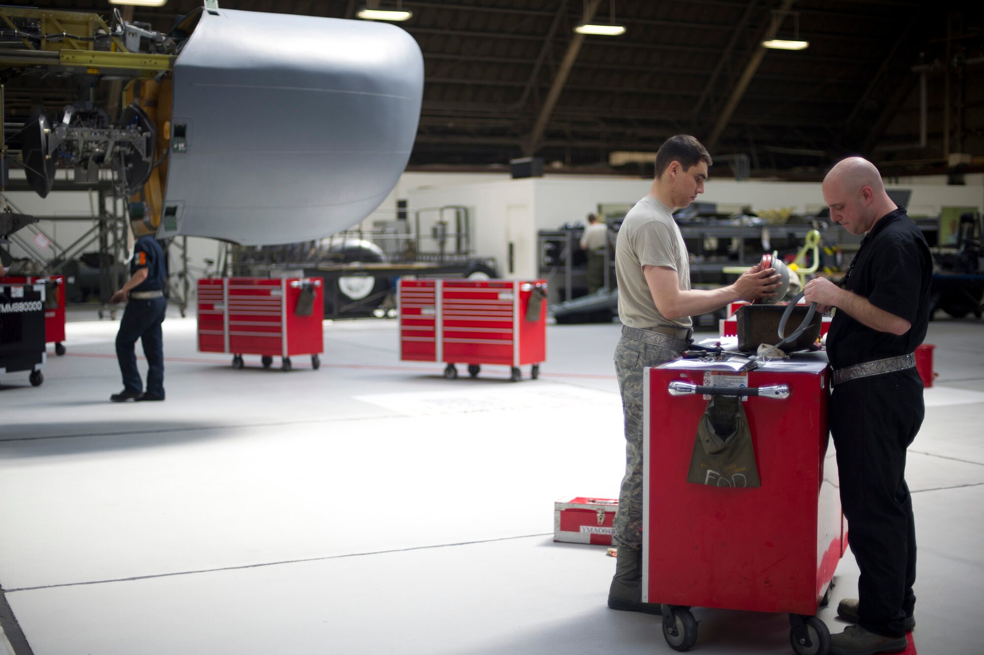 YOKOTA AIR BASE, Japan -- Left to right, Senior Airman Pedro Laris-Sandoval and Staff Sgt. Lore, both from the 374th Maintenance Squadron, prepare a landing light before it is installed into the wing during an isochronal inspection on a C-130 Hercules May 14, 2012, at Yokota Air Base, Japan. The inspection consists of dividing the plane into five sections and takes approximately 15 days to complete. (U.S Air Force photo by Staff Sgt. Stacy Moless)