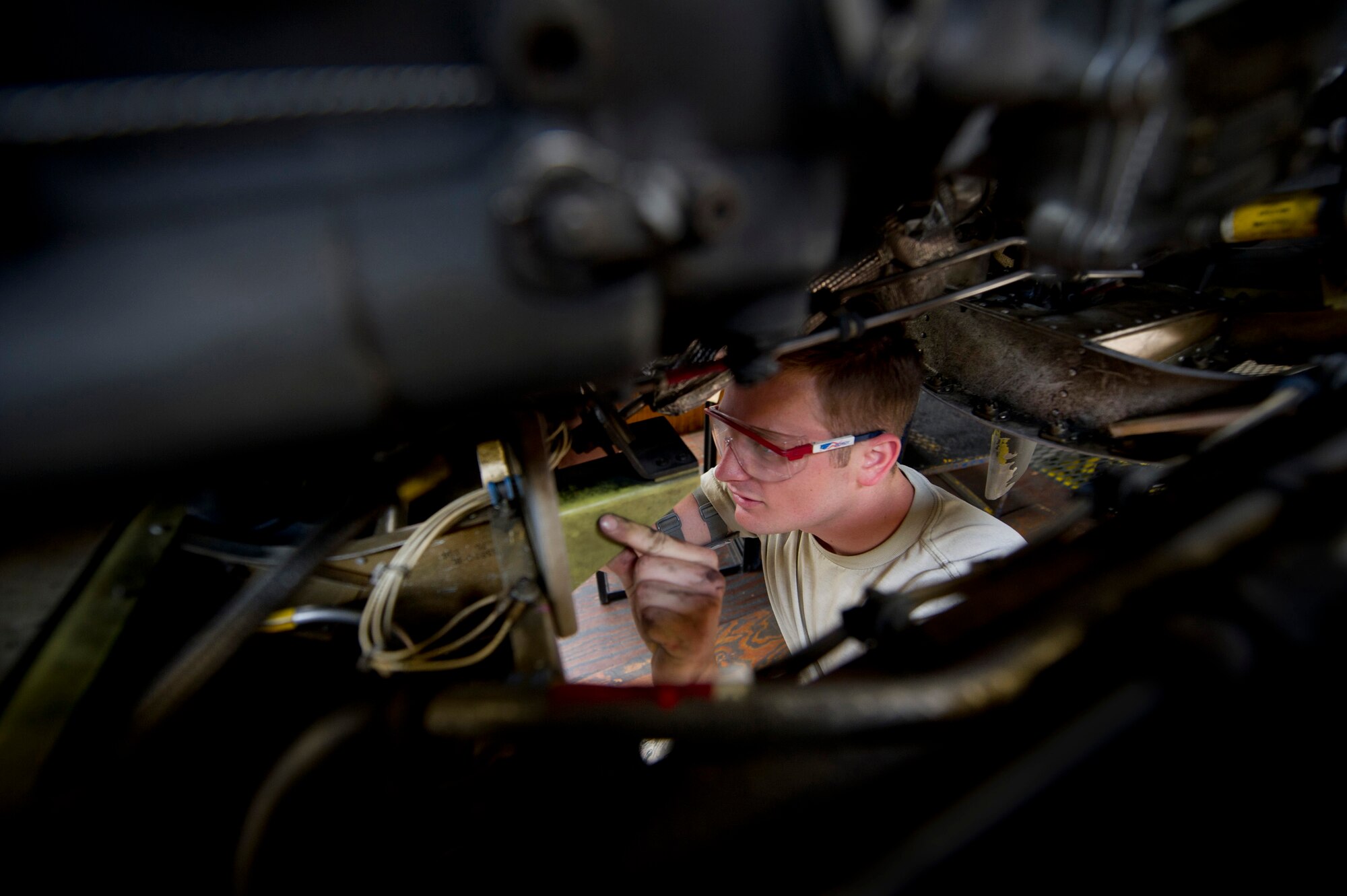 YOKOTA AIR BASE, Japan -- Airman 1st Class Mitchell McGarry, 374th Maintenance Squadron, installs an oil cooler flap actuator support bracket on a C-130 Hercules during an isochronal inspection at Yokota Air Base, Japan, May 14, 2012. Every plane undergoes an isochronal inspection, which consists of a 15-day detailed inspection before the plane can fly again. (U.S Air Force photo by Staff Sgt. Stacy Moless)
