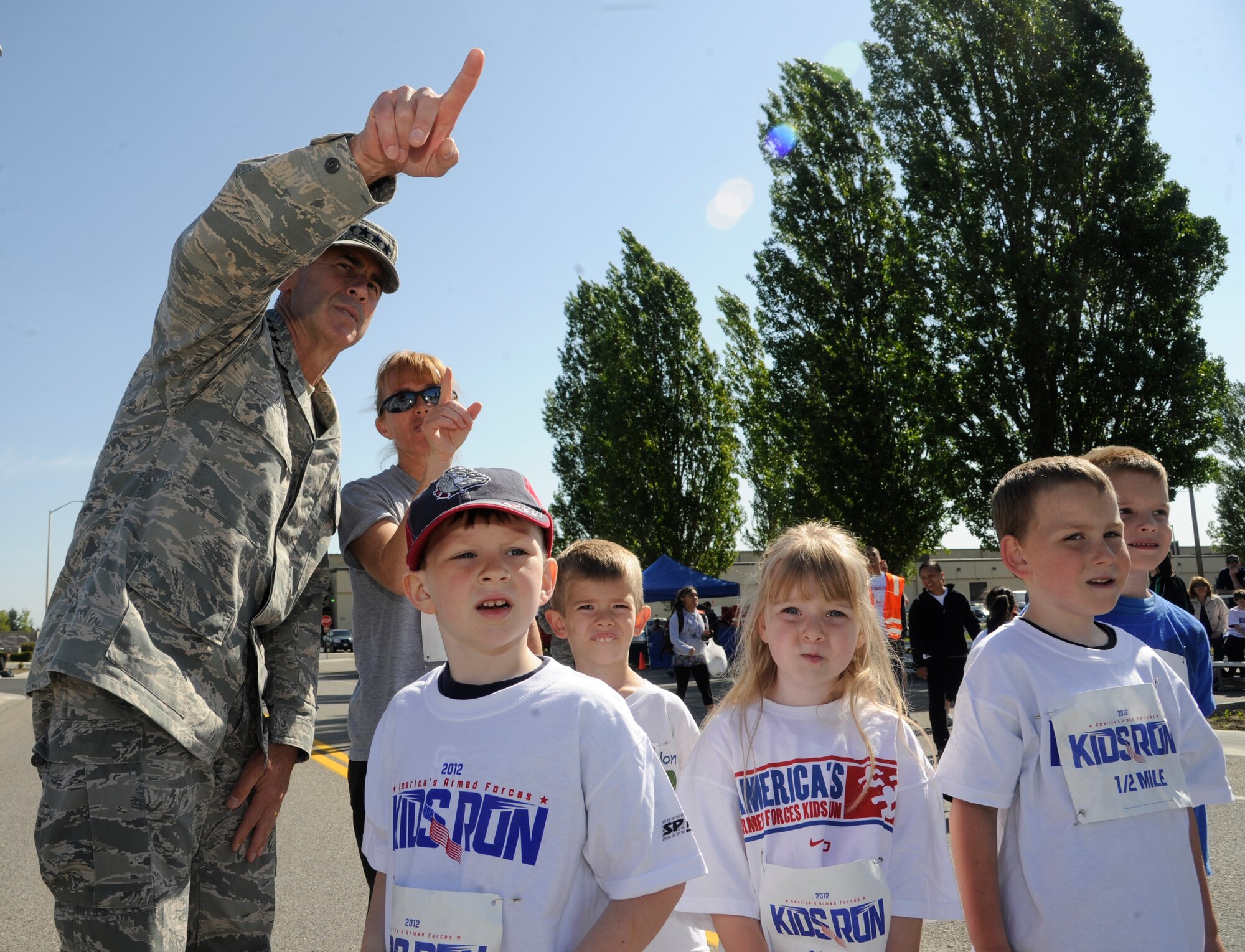 Gen. Raymond Johns Jr., Air Mobility Command commander, points out the finish line to participants of the America’s Kids Run event outside the fitness center at Fairchild Air Force Base, Wash., May 19, 2012. The annual event began in 1986 as Junior Bloomsday, the child's answer to the annual Bloomsday race held in Spokane, Wash., every May. (U.S. Air Force photo by Airman 1st Class Ryan Zeski/Released