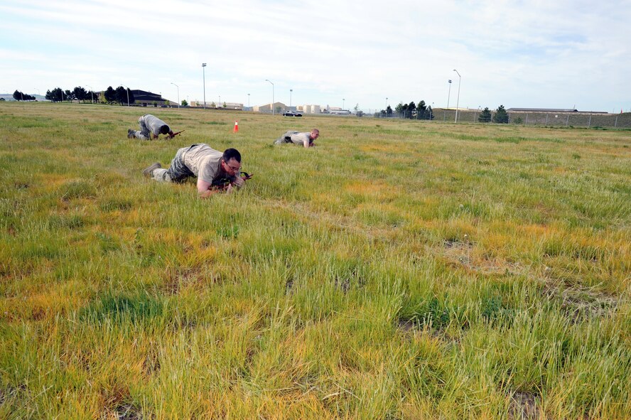 Airmen from the 92nd Security Forces Squadron high crawl as part of the “Battle of the Badges” competition during National Police Week at Fairchild Air Force Base, Wash., May 16, 2012. National Police Week occurs each year in recognition of the service and sacrifice of U.S. law enforcement members. (U.S. Air Force photo by Senior Airman Benjamin Stratton/Released)