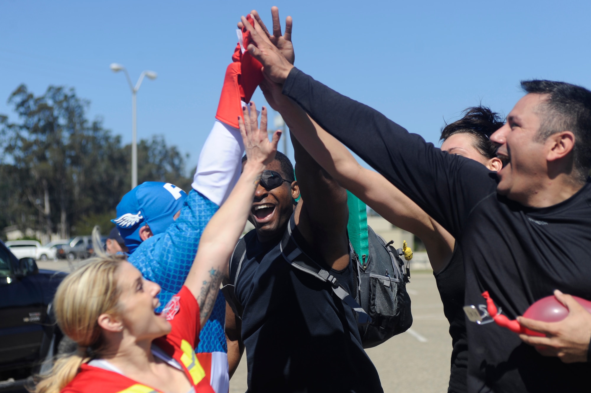 VANDENBERG AIR FORCE BASE, Calif. --The 30th Medical Group team high-fives  during Vandenberg's Run to Survive Safety Competition at the parade grounds here Tuesday, May 22, 2012. The competition had the participants run around to multiple locations on base testing their safety skills and knowledge. (U.S. Air Force photo/Staff Sgt. Andrew Satran)  