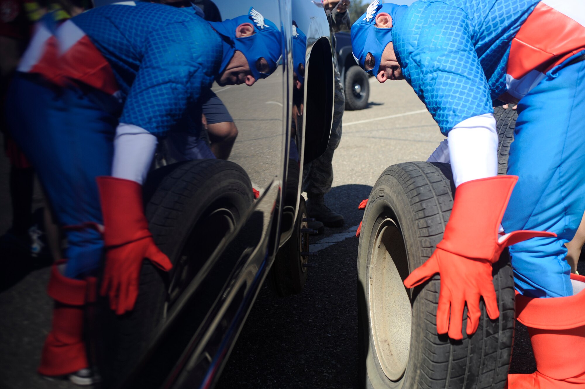 VANDENBERG AIR FORCE BASE, Calif. -- Lt. Col. Daniel Murray, 30th Medical Group chief of aerospace medicine, changes a tire during Vandenberg's Run to Survive Safety Competition at the parade grounds here Tuesday, May 22, 2012. The competition had the participants run around to multiple locations on base testing their safety skills and knowledge. (U.S. Air Force photo/Staff Sgt. Andrew Satran)  